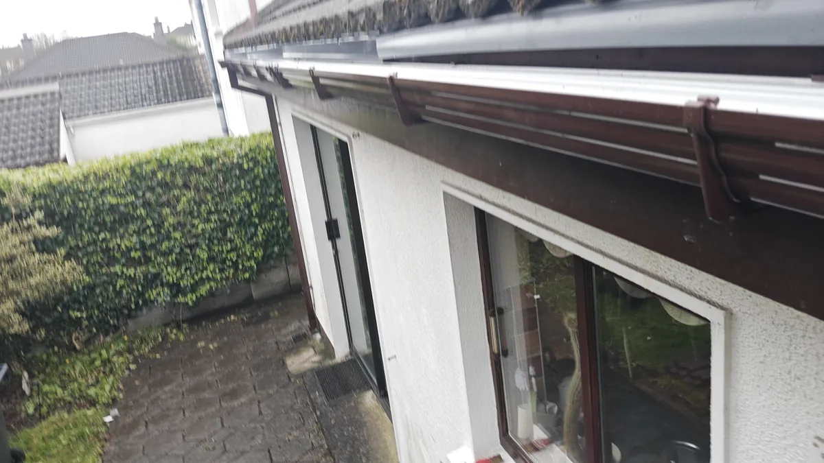 Brown uPVC fascia and white soffit running the length of a roofline